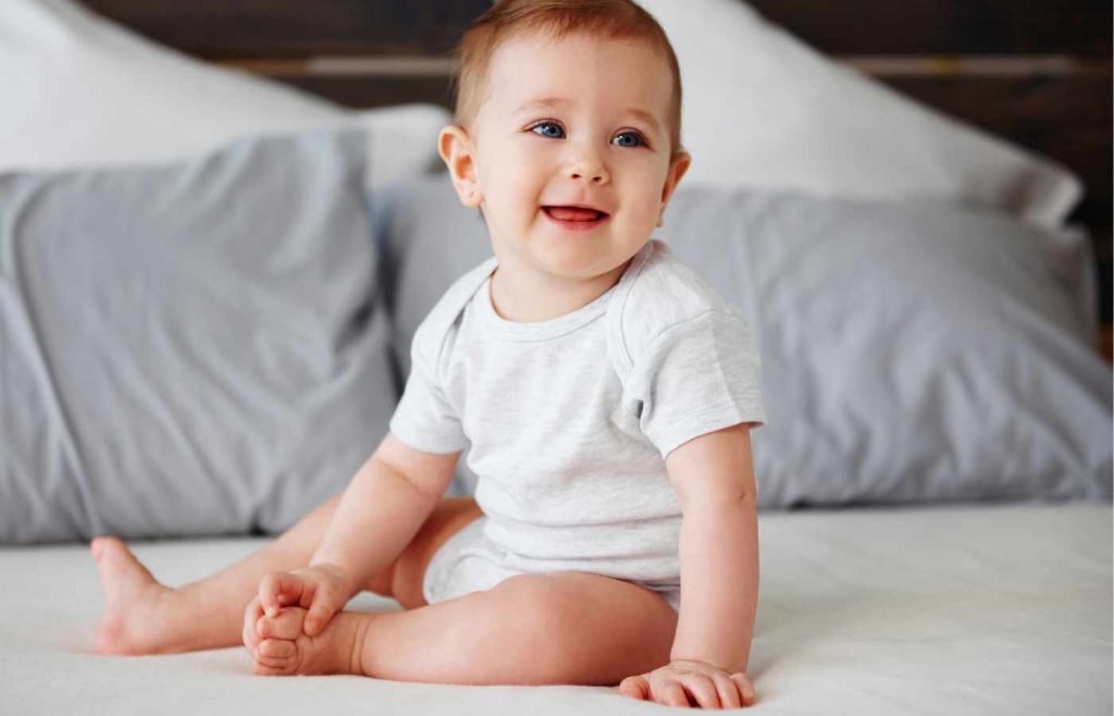 A smiling baby with torticollis