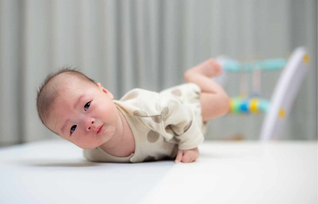 A baby with torticollis rolls over during tummy time