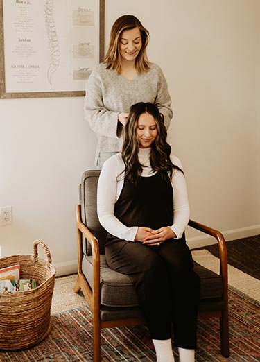 pregnancy-adjustment2-well-family-chiro Dr Hannah adjusting a pregnant woman at Well Family Chiropractic in Mequon, WI